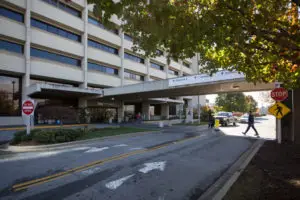 Mission hospital entrance with cement covering across sidewalk from garage to entrance