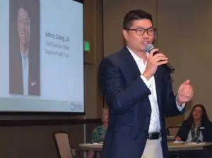 Andrew Chiang speaker at banquet in front of projector screen