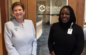 Janice W. Brumit, Chair standing with Lakesha West in fron tof Dogwood Health Trust office door.