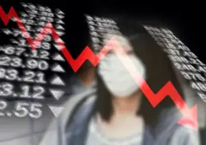 Stock numbers with red plumeting arrow and woman in face mask blurred out in the backgroun