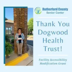 Woman olding up grant check with "Thank you Dogwood Health Trust" on the side