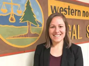 Suzanne Saucier standing in front of Western North Carolina Legal Services Mural