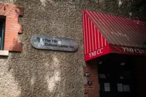 Close up on a sign outside the YMI Cultural Center Inc. Office.