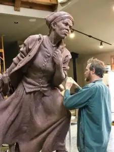 Wesley Wofford puts the finishing touches on the bronze sculpture “Harriett Tubman - Journey to Freedom.”