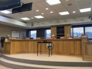 Avery County Commissioner Dennis Aldridge makes a point while assistant county manager Cindy Turbyfill and commissioners Martha Hicks and Tim Phillips intently listen.