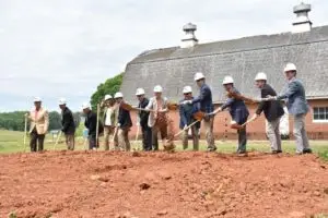 Group of people with shovels and hard hats