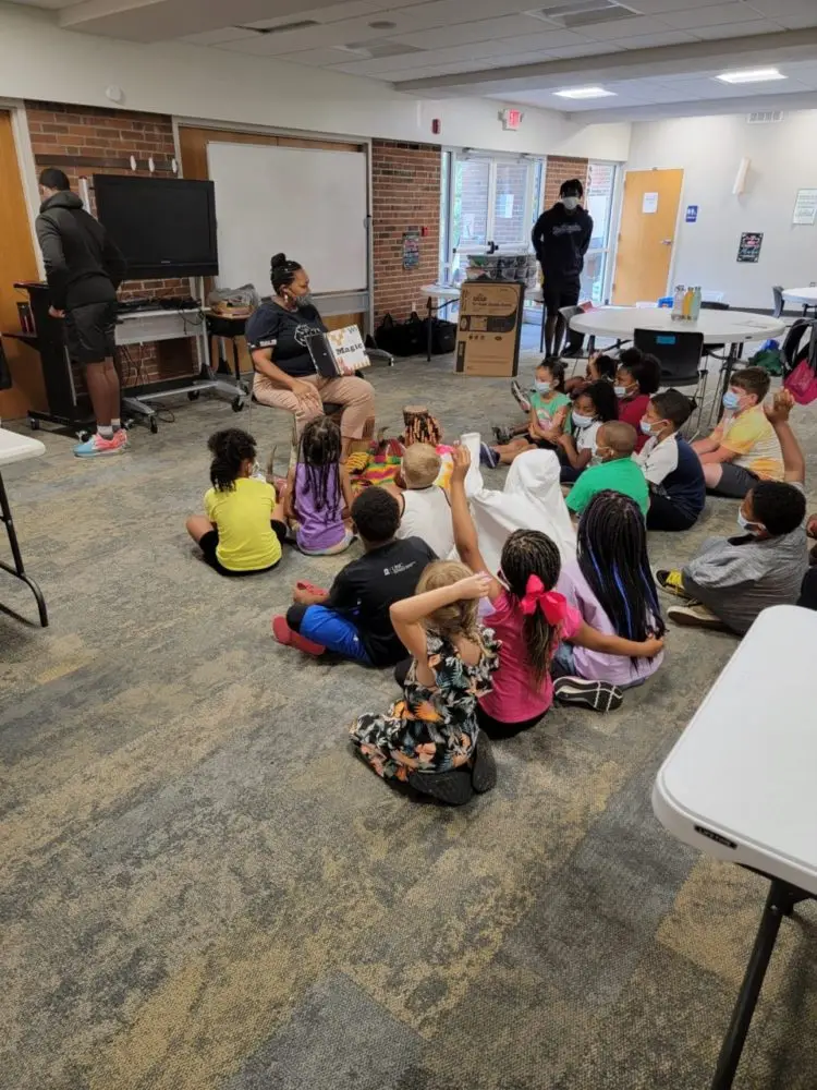 Woman reading to school children