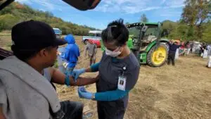 Nurse treating a farm worker