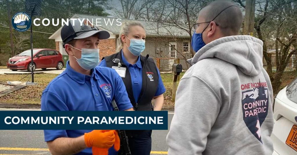 Paramedics talking to a man