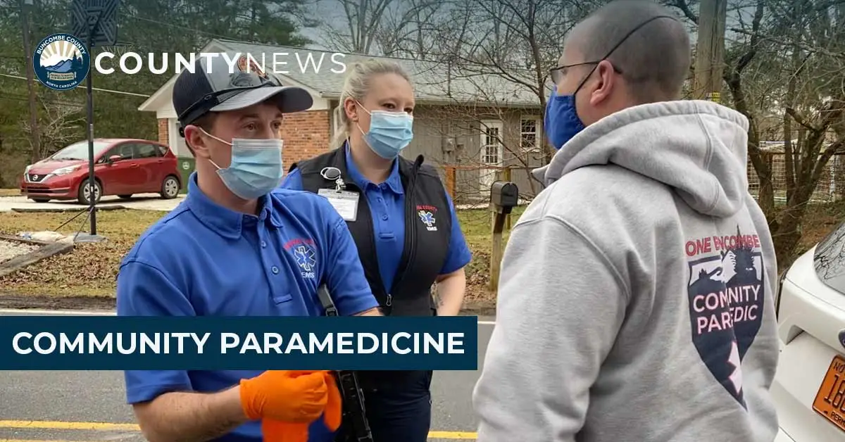 Paramedics talking to a man