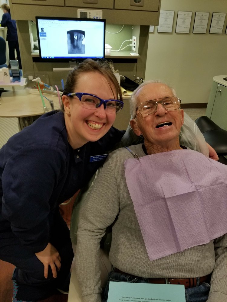 Older man getting fee dental check at a clinic