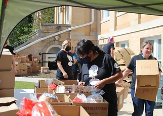 Volunteers creating bagged meals