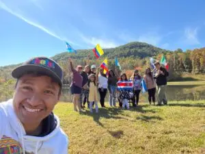 Hola Carolina team posing with an assortment of Latin American Flags