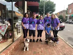 Family participating the Elder abuse awareness walk with their dogs