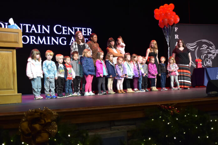 Small children on stage at event