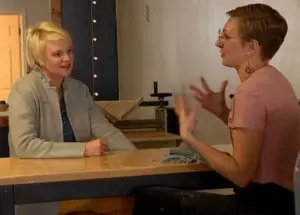 2 women talking at a table