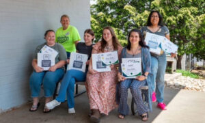 Educators holding up certificates having completed Fast Track provided by North Carolina Child Care Academies