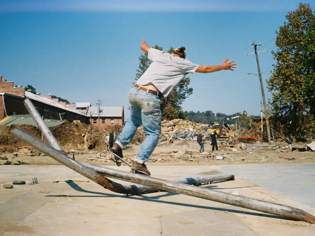 skateboarder 50-50 grind on fallen metal pipe caused by hurricane helene