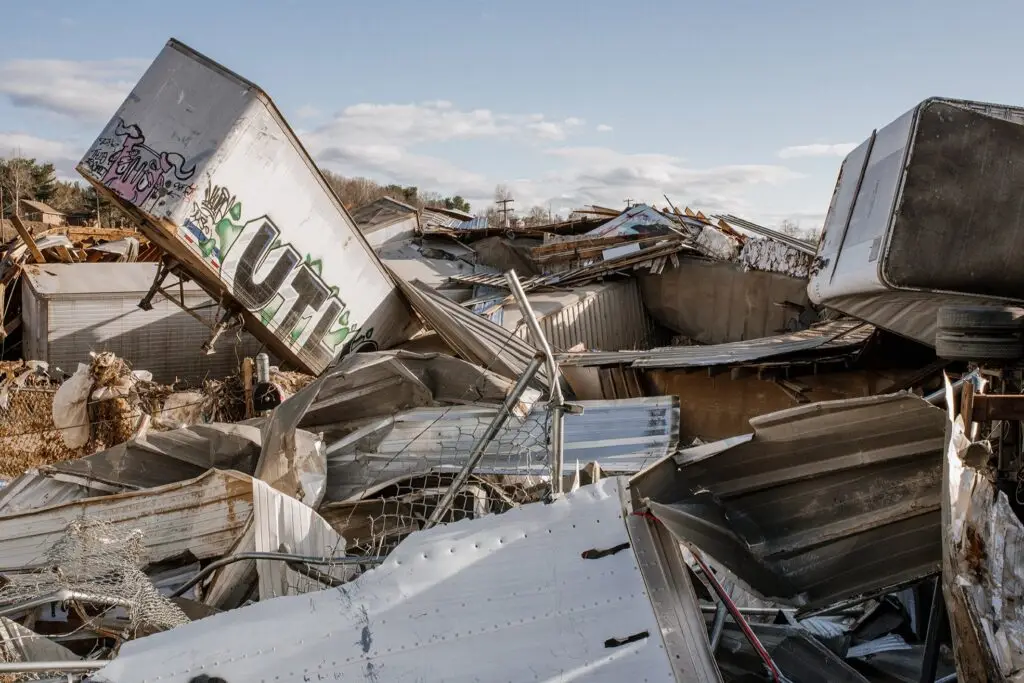 A chaotic scene of debris from collapsed trailers and metal structures caused by Hurricane Helene in North Carolina