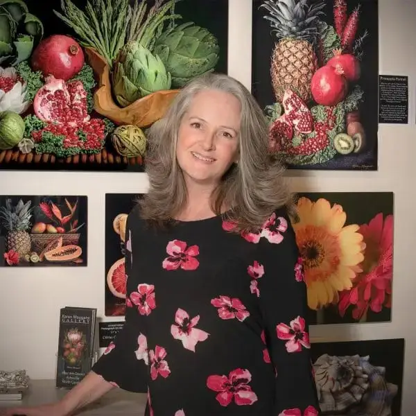 Karen Maugans smiling in front of art