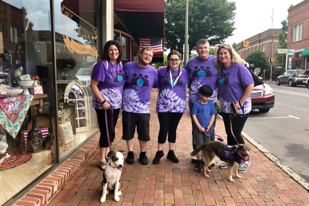 Family participating the Elder abuse awareness walk with their dogs
