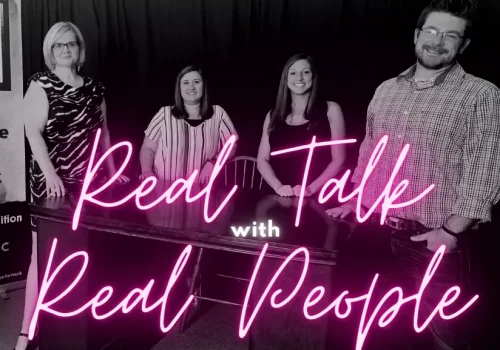 Burke Recovery Staff standing in front of desk with pink text reading "Real Talk with Real People"